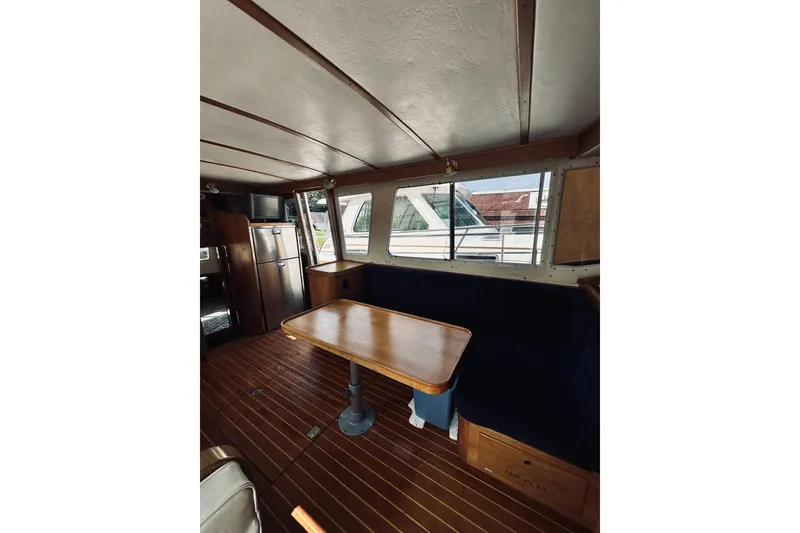 Slide: The Image of Interior of 1996 Sabreline 36 Sedan with wooden table and seating area. - 26