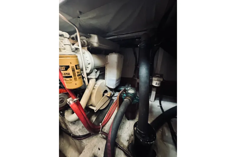 Slide: The Image of Engine compartment of a 1996 Sabreline 36 Sedan boat, featuring CAT components. - 73