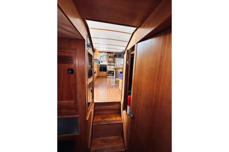 Slide: The Image of Interior view of 1996 Sabreline 36 Sedan, showcasing wooden cabinetry and steps. - 41