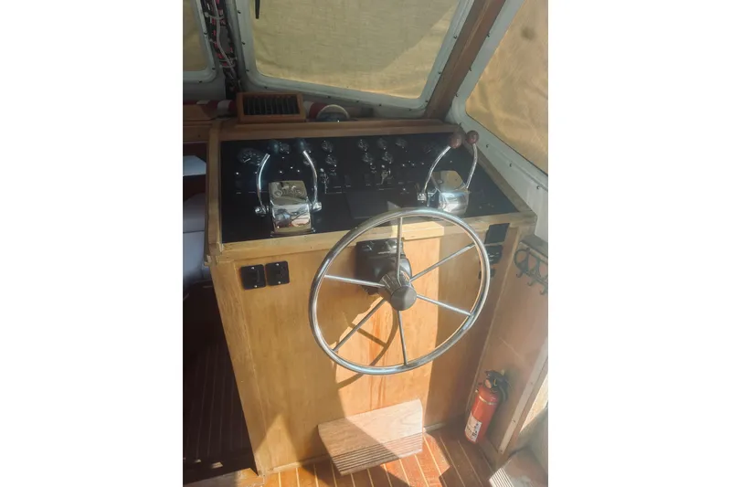 Slide: The Image of Helm of 1996 Sabreline 36 Sedan with steering wheel and control panel. - 31