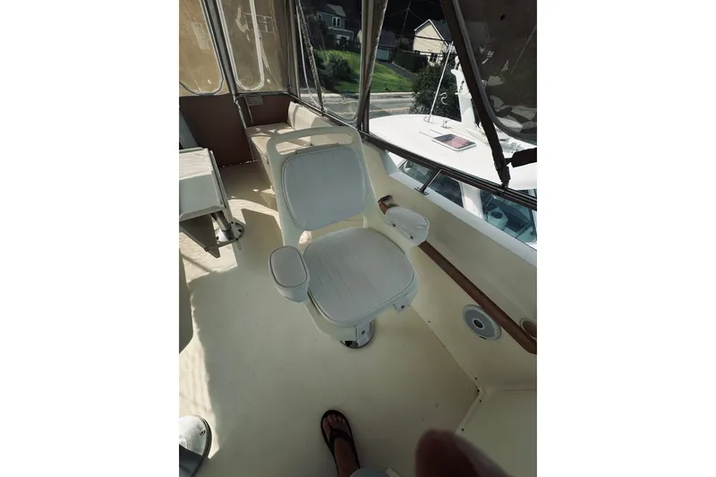 Slide: The Image of Interior of 1996 Sabreline 36 Sedan boat with white captain's chair. - 95