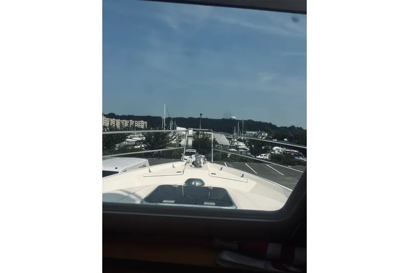 Slide: The Image of 1996 Sabreline 36 Sedan yacht view from cabin, overlooking marina and clear sky. - 37