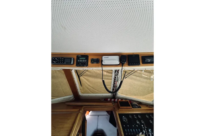 Slide: The Image of Interior view of a 1996 Sabreline 36 Sedan boat cockpit with navigation equipment. - 32