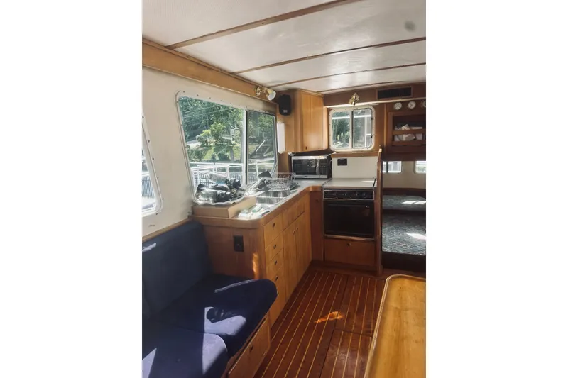 Slide: The Image of Interior of 1996 Sabreline 36 Sedan yacht with wooden cabinetry and seating. - 24