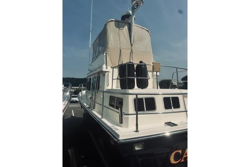 Slide: The Image of 1996 Sabreline 36 Sedan yacht docked under clear blue sky. - 11