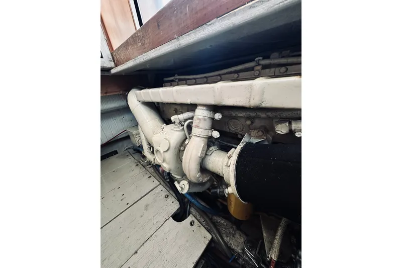Slide: The Image of Engine compartment of a 1996 Sabreline 36 Sedan boat, showcasing mechanical components. - 76