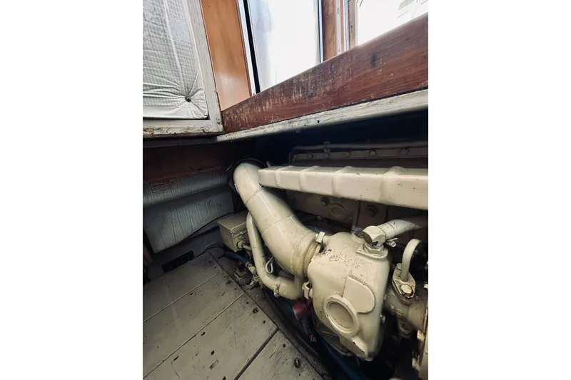 Slide: The Image of Engine compartment of a 1996 Sabreline 36 Sedan boat, showcasing mechanical components. - 77