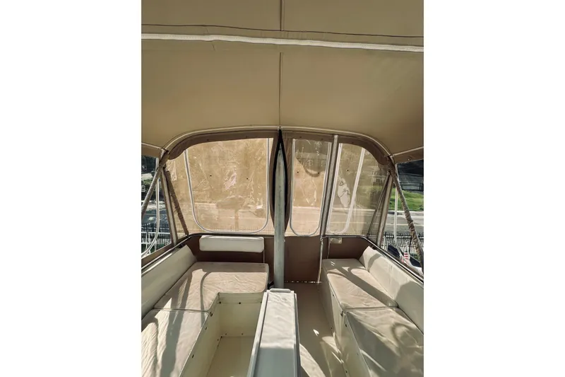 Slide: The Image of Interior view of 1996 Sabreline 36 Sedan boat with beige seating and canopy. - 104
