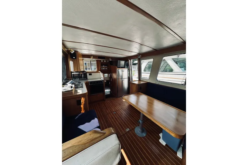 Slide: The Image of Interior of 1996 Sabreline 36 Sedan yacht with wooden furnishings and modern appliances. - 27