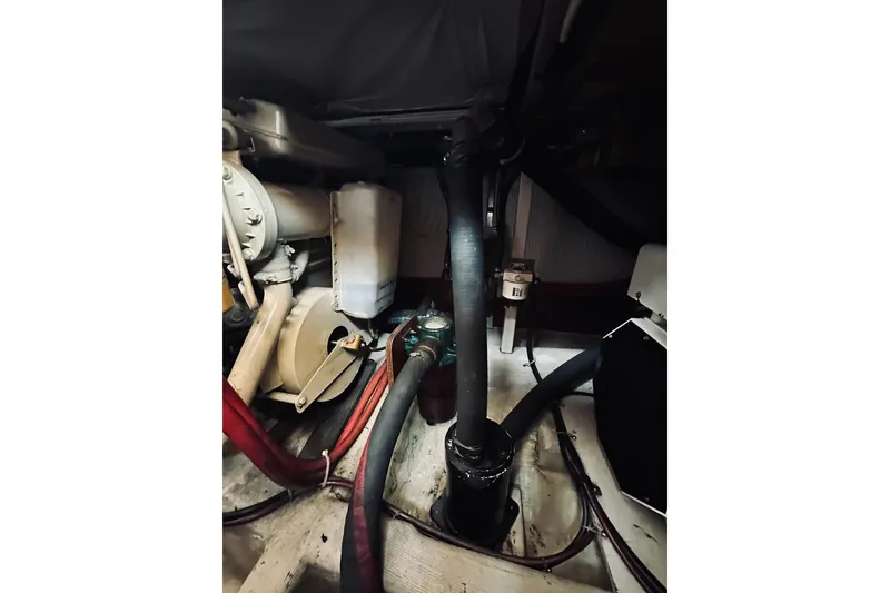 Slide: The Image of Engine room of a 1996 Sabreline 36 Sedan boat, showing mechanical components and hoses. - 72