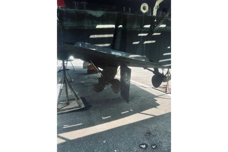 Slide: The Image of 1996 Sabreline 36 Sedan boat propeller and rudder in dry dock. - 6