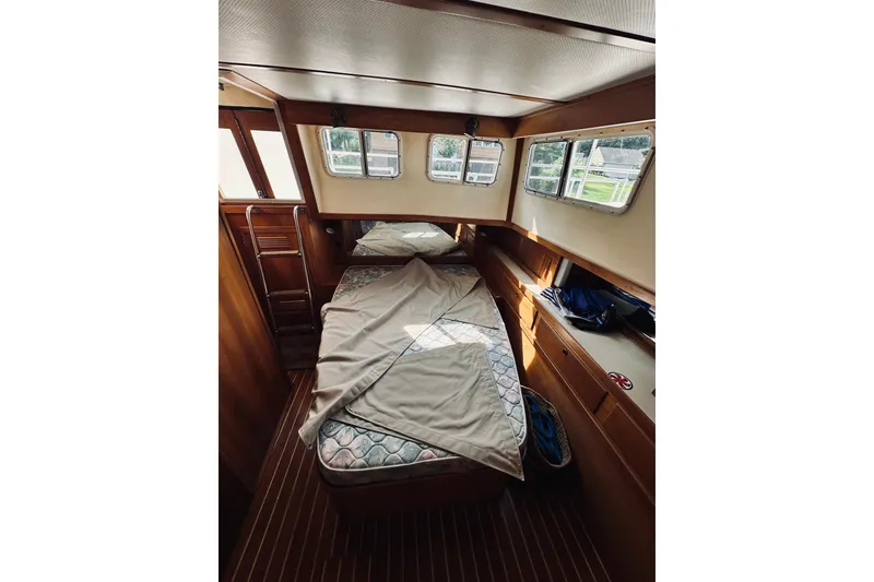 Slide: The Image of 1996 Sabreline 36 Sedan cabin interior with bed and wooden furnishings. - 45