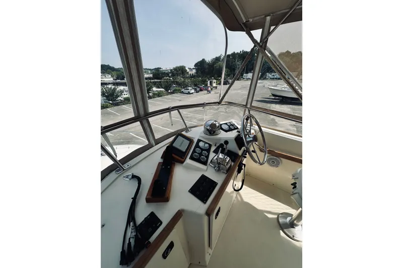 Slide: The Image of 1996 Sabreline 36 Sedan helm with steering wheel and navigation controls. - 91