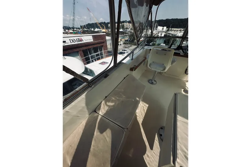 Slide: The Image of 1996 Sabreline 36 Sedan boat interior with seating and helm, docked at marina. - 86
