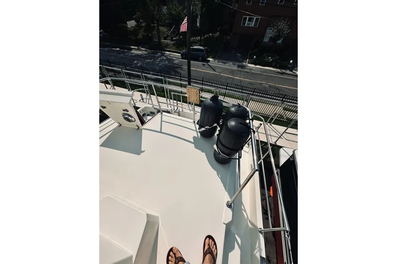 Slide: The Image of Deck view of a 1996 Sabreline 36 Sedan boat with fenders and railing. - 80