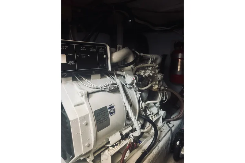 Slide: The Image of Engine room of a 1996 Sabreline 36 Sedan with visible control panel and wiring. - 58