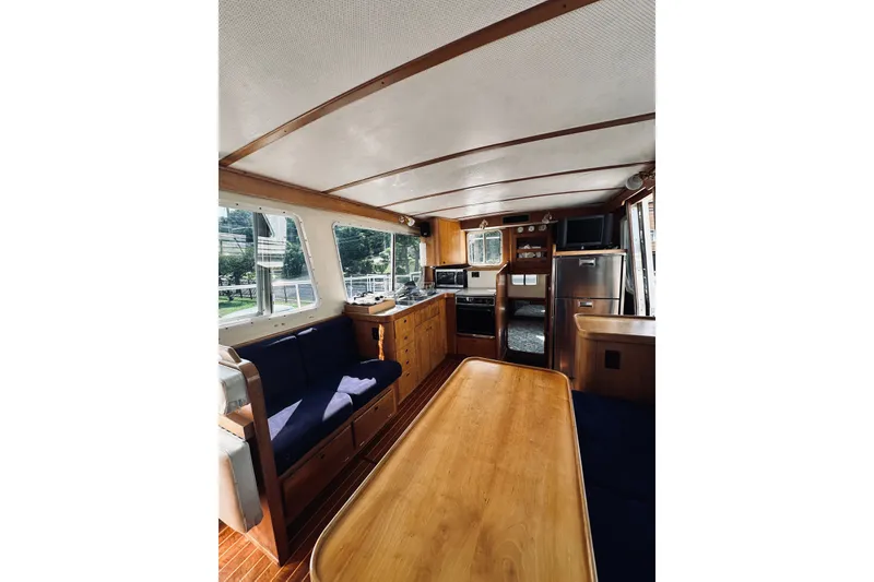 Slide: The Image of Interior of 1996 Sabreline 36 Sedan yacht with wooden furnishings and blue seating. - 28
