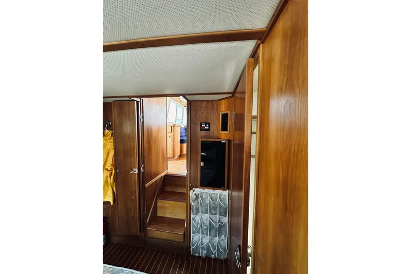 Slide: The Image of Interior of 1996 Sabreline 36 Sedan, featuring wooden paneling and steps leading to the helm. - 50