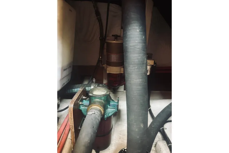 Slide: The Image of Engine room of a 1996 Sabreline 36 Sedan with visible hoses and components. - 61