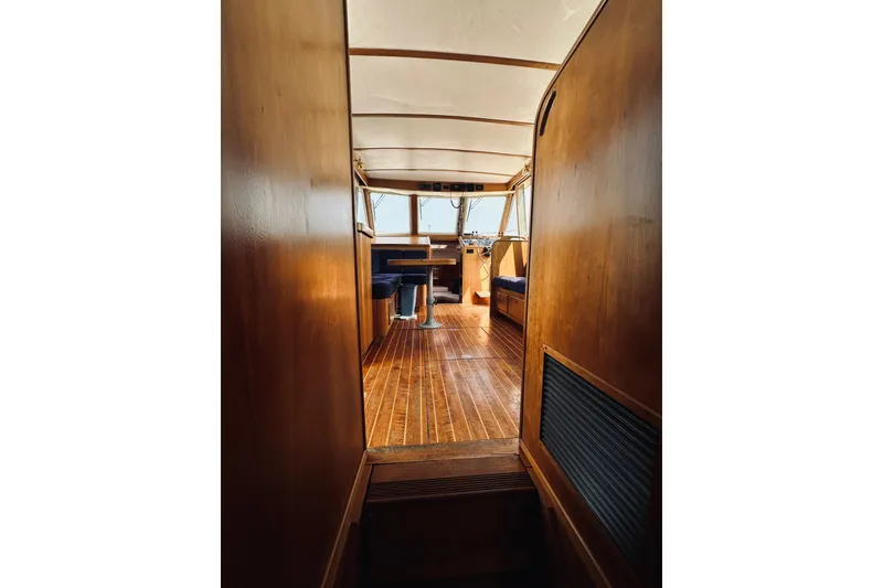 Slide: The Image of Interior view of 1996 Sabreline 36 Sedan, showcasing wooden flooring and seating area. - 34