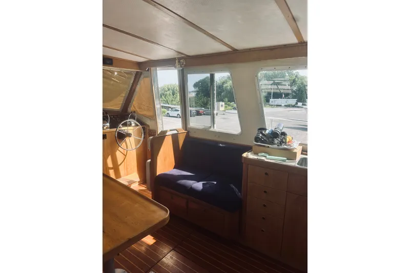 Slide: The Image of Interior of 1996 Sabreline 36 Sedan boat with wooden furnishings and steering wheel. - 22