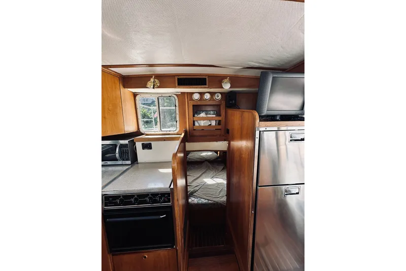 Slide: The Image of Interior of 1996 Sabreline 36 Sedan with kitchen and sleeping area. - 44
