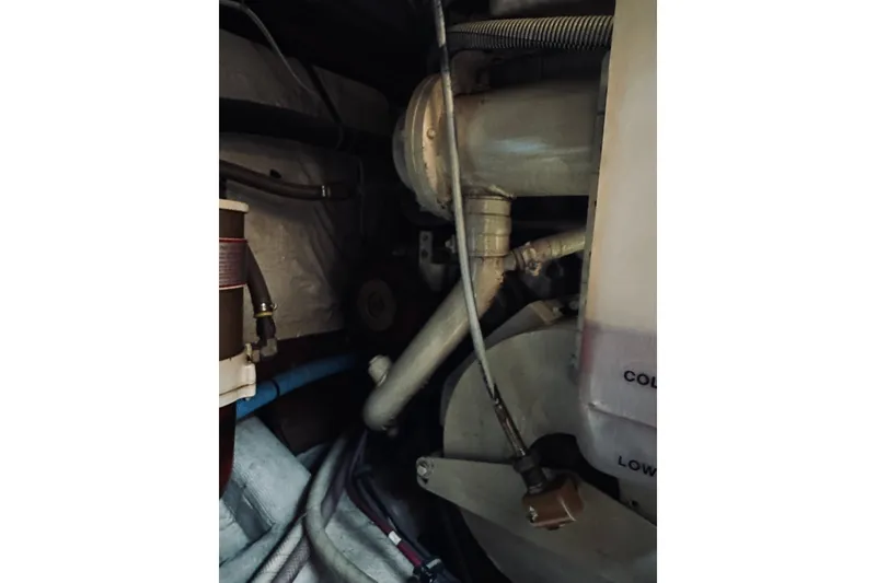 Slide: The Image of Engine compartment of a 1996 Sabreline 36 Sedan boat, showing pipes and components. - 66
