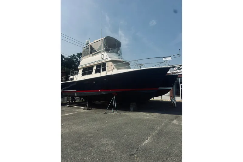 Slide: The Image of 1996 Sabreline 36 Sedan boat on dry dock under clear sky. - 1