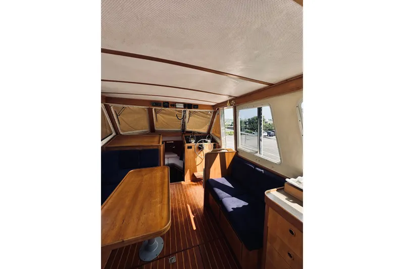 Slide: The Image of Interior of 1996 Sabreline 36 Sedan boat with wooden furnishings and blue seating. - 30