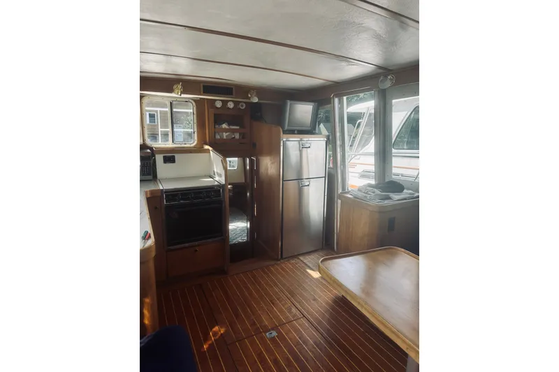 Slide: The Image of Interior of 1996 Sabreline 36 Sedan yacht with kitchen and dining area. - 25