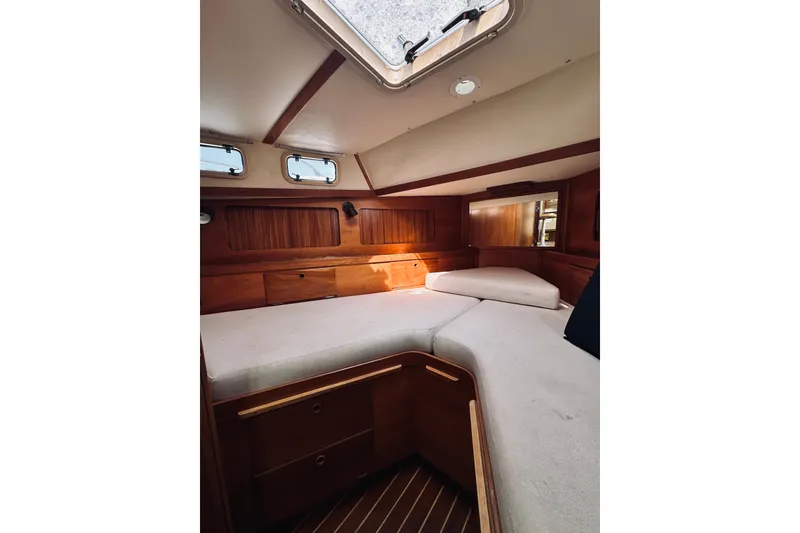 Slide: The Image of Interior cabin of 1996 Sabreline 36 Sedan with wooden finish and cozy seating. - 38