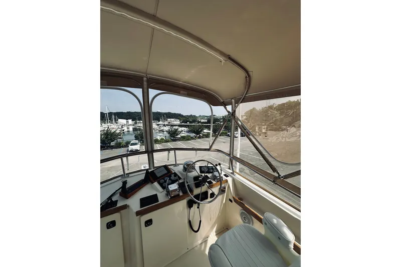 Slide: The Image of Interior view of 1996 Sabreline 36 Sedan boat cockpit with steering wheel and controls. - 100