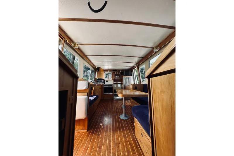Slide: The Image of Interior of a 1996 Sabreline 36 Sedan yacht with wooden furnishings and seating. - 43