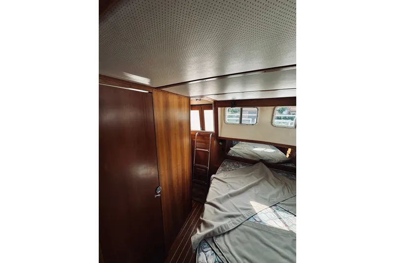 Slide: The Image of Interior cabin of a 1996 Sabreline 36 Sedan with wood paneling and windows. - 46