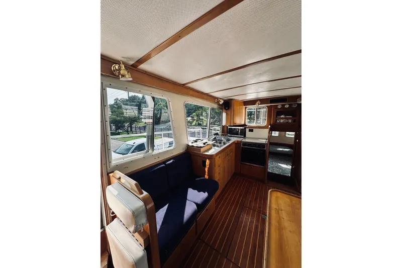 Slide: The Image of Interior of a 1996 Sabreline 36 Sedan yacht with wood paneling and blue seating. - 29