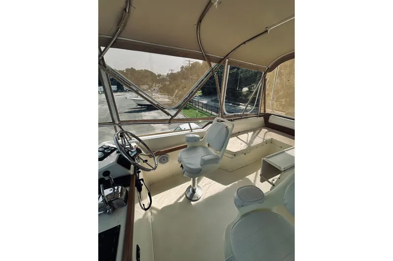 Slide: The Image of Interior view of 1996 Sabreline 36 Sedan boat with helm and seating area. - 90