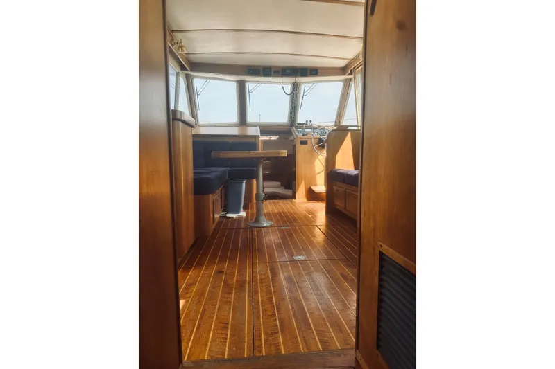 Slide: The Image of Interior of 1996 Sabreline 36 Sedan boat with wooden flooring and seating area. - 35