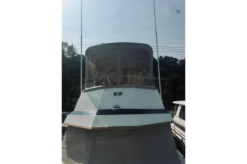 Slide: The Image of 1996 Sabreline 36 Sedan boat with covered deck, docked outdoors. - 17