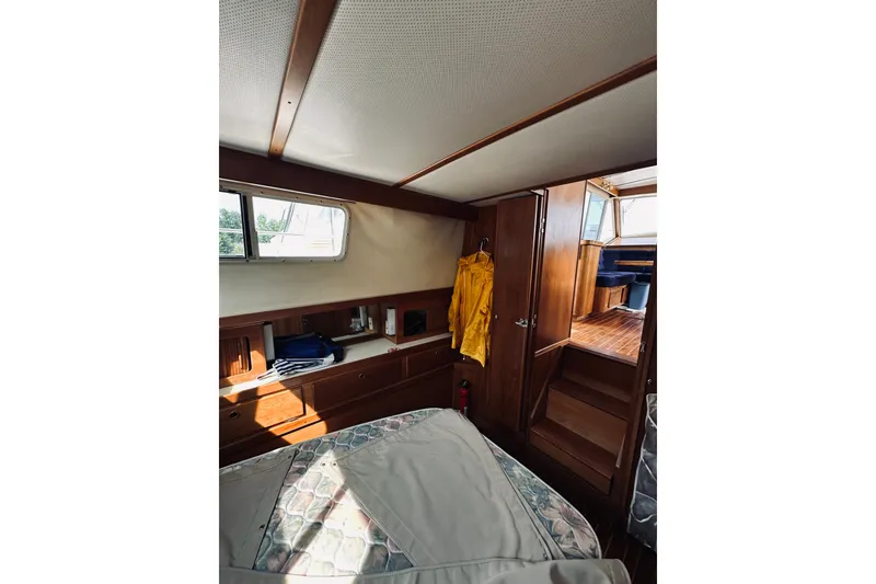 Slide: The Image of 1996 Sabreline 36 Sedan cabin interior with wooden finish and cozy furnishings. - 49