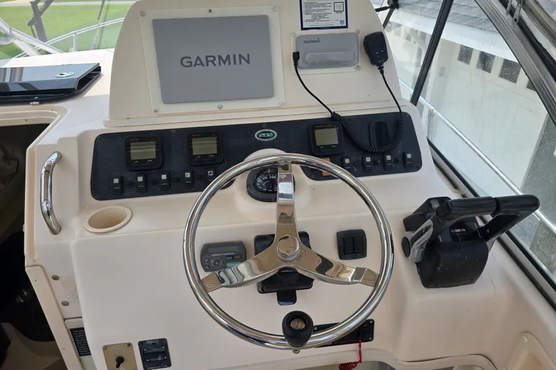 Slide: The Image of Helm of 2008 Grady White 282 Sailfish with Garmin navigation system and controls. - 16