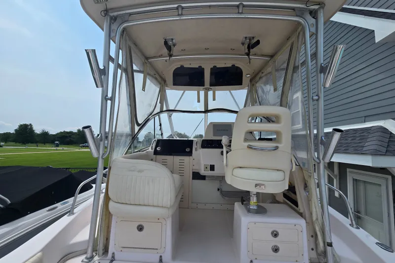 Slide: The Image of 2008 Grady White 282 Sailfish boat cockpit with helm and seating area. - 14