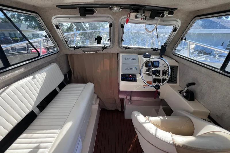 Slide: The Image of Interior of 2012 Parker 2320 SL Sport Cabin with steering wheel and Garmin navigation. - 24