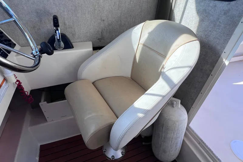 Slide: The Image of Captain's chair in 2012 Parker 2320 SL Sport Cabin boat cockpit. - 27