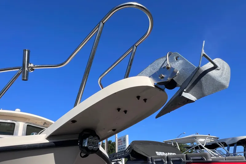 Slide: The Image of Bow of 2012 Parker 2320 SL Sport Cabin with anchor and railing against blue sky. - 7