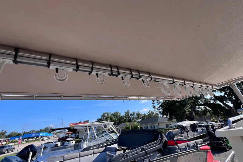 Slide: The Image of 2012 Parker 2320 SL Sport Cabin boat with canopy and docked in marina. - 18