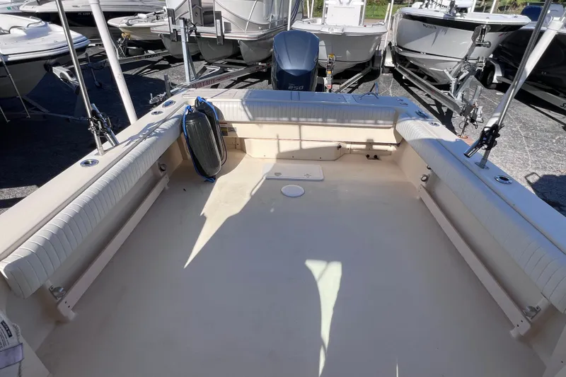 Slide: The Image of 2012 Parker 2320 SL Sport Cabin boat interior with seating and fishing rod holders. - 11