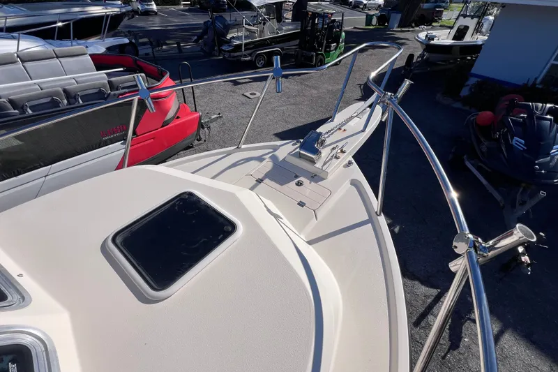 Slide: The Image of 2012 Parker 2320 SL Sport Cabin boat deck with railing and hatch. - 21