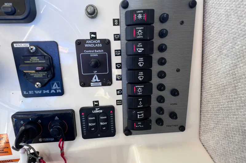 Slide: The Image of Control panel of a 2012 Parker 2320 SL Sport Cabin boat with switches and indicators. - 30