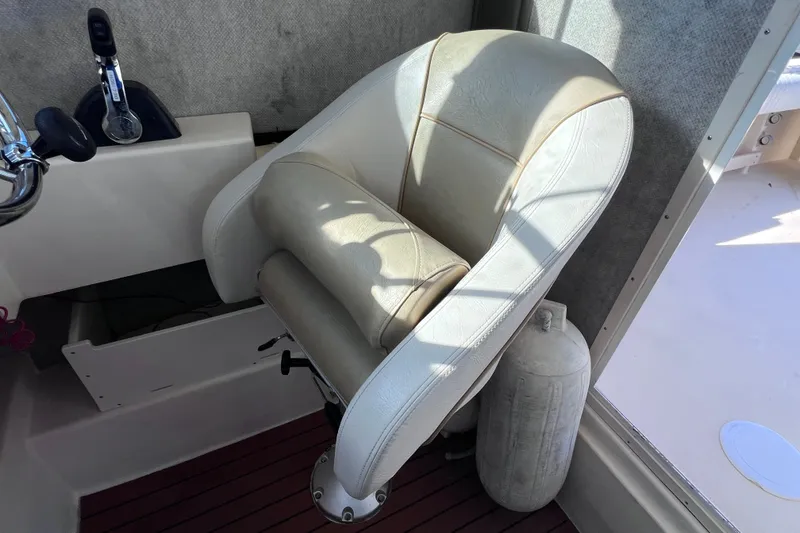 Slide: The Image of Captain's chair in 2012 Parker 2320 SL Sport Cabin boat interior. - 28