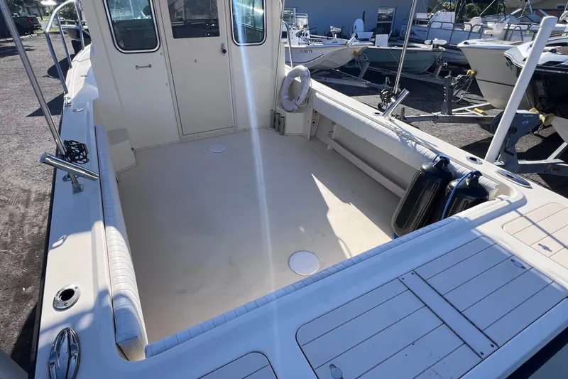 Slide: The Image of 2012 Parker 2320 SL Sport Cabin boat interior, spacious deck, and seating area. - 9